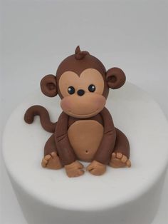 a cake with a monkey sitting on top of it