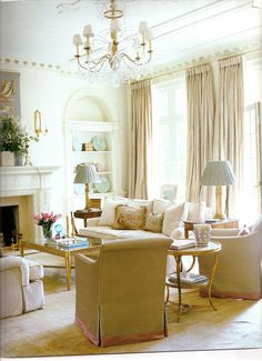 a living room filled with furniture and a chandelier