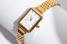 Elevate your style with the Mila 18K Gold Watch. The Mila 18K Gold Watch combines minimalist design with timeless elegance, perfect for any outfit or occasion. It's sleek design expertly combines its lightweight, comfortable feel, and a polished 18K gold finish making it ideal for everyday wear or special occasions. The Mila 18K Gold Watch is made with premium quality stainless steel and expertly coated with polished 18K gold that gives it a refined look that radiates modern sophistication. This Elegant Gold Stainless Steel Watch Accessories, Minimalist Rectangular Dial Watch For Everyday, Minimalist Quartz Watch For Formal Occasions, Minimalist Rectangular Dial Watches For Everyday, Minimalist Everyday Watch With Rectangular Dial, Minimalist Quartz Watches For Formal Occasions, Everyday Minimalist Watch With Rectangular Dial, Gold Minimalist Watch For Everyday Use, Everyday Gold Minimalist Watch