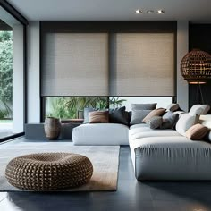 a living room filled with lots of furniture next to a large window covered in blinds