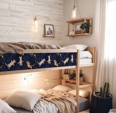 there is a bunk bed that has cats on it and stars in the night sky