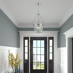 a foyer with blue walls and white trim