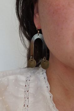 Geometric Earrings Arch Color: Black Material: Metal Circles: Color: Antique Brass Material: Brass Hardware Color: Gold Material: Iron Arches are a black metal, and the circles are antique brass. Nickel-free Black Metal Plug Earrings, Black Brass Earrings, Bronze Oxidized Metal Earrings, Nickel-free Black Brass Earrings, Vintage Metal Circle Earrings, Bronze Circle Brass Earrings, Bronze Circular Brass Earrings, Black Bohemian Brass Earrings, Bohemian Black Brass Earrings