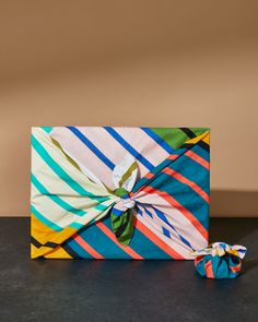 a wrapped gift box sitting on top of a table