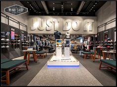 the inside of a shoe store with lots of shoes on display