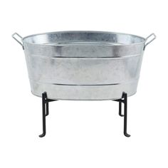 a large metal tub sitting on top of a black stand