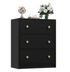 a black and gold dresser with flowers on top