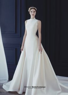 a woman in a white wedding dress with a crown on her head