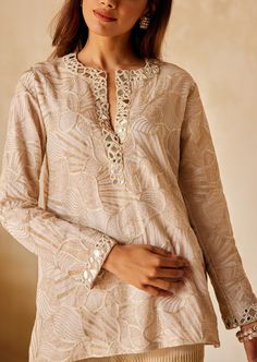 The tunic embodies a relaxed fit top with a plunging neckline with detailed mirrorwork and beadwork. Festive V-neck Kurta With Intricate Embroidery, Bohemian V-neck Top With Resham Embroidery, Embellished V-neck Kurta For Party, Festive Embellished V-neck Kaftan, Festive Embellished Straight Kurta Top, Designer Embroidered Neckline Tunic Kurta, Designer Embroidered Neckline Kurta Tunic, Traditional Festive Embellished Tunic, Festive Traditional Embellished Tunic