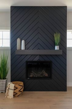 a living room with a fire place and potted plants