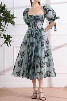 Unleash your inner elegance with our Corset Floral Print Organza Midi Dress. Featuring a delicate organza fabric adorned with a beautiful floral print, this dress exudes luxury. Add a touch of drama by attaching the removable puff sleeves, perfect for any special occasion. Elevate your style with this sophisticated and exclusive piece. Bust and Skirt with full lining. 100% Polyester 100% Recycled polyester lining Concealed zip at center back Imported Elegant Organza Puff Sleeve Party Dress, Formal Floral Organza Dress, Party Floral Dress With Puff Sleeves, Elegant Organza Puff Sleeve Dress For Party, Elegant Organza Puff Sleeve Dress For Wedding, Floral Print Puff Sleeve Dress For Party, Elegant Organza Puff Sleeve Dress For Evening, Formal Floral Print Chiffon Dress For Summer, Formal Summer Chiffon Dress With Floral Print