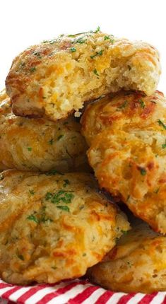 a pile of crab cakes sitting on top of a red and white striped napkin