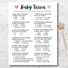 the baby trivia game is shown on top of a white sheet with pink and blue hearts