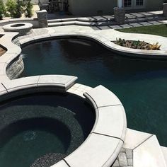 an outdoor swimming pool in the middle of a yard with stone steps leading up to it