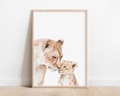 a painting of a mother lion and her cub in front of a white wall with wood flooring