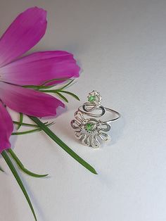 Flower toe ring. Delicate ring for fingers or toes--petite flower. Versatile and fun. Wear it as a foot ring with flip-flops or strappy heels. Wear it as a midi ring between your knuckles. Wear it folded and mixed with other rings to create new combinations. Choice of silver or bronze finish. Perfect little gift. The ring is made in Wire wrap technique, elements of coinage, from silver 925, copper or bronze wire with natural rhodochrosite, turquoise, malachite, and also you can order the ring with other stones, pre-negotiate with me. The ring is artificially aged chemically, polished and coated with protective varnish. The ring size is adjustable.  In the package You will receive one ring for the toe, which select from the options. Pay attention If You like thicker and more powerful rings, Delicate Adjustable Rings For Spring, Silver Nickel-free Toe Ring With Flower Design, Silver Nickel-free Flower Toe Ring, Adjustable Flower-shaped Promise Ring, Adjustable Silver Toe Ring With Flower Design, Adjustable Sterling Silver Crystal Ring For May Birthstone, Adjustable Crystal Flower Ring, Delicate Adjustable Open Flower Ring, Adjustable Green Dainty Rings