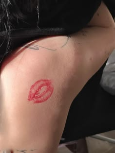 a woman with red lipstick on her back