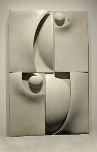 an abstract sculpture is displayed on the wall