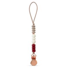 a pacifier is hanging from a cord with beads on the end and an orange bead