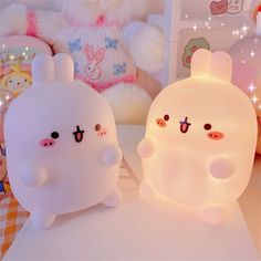 two white bunny lamps sitting on top of a table