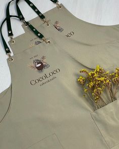 two aprons that have flowers in them