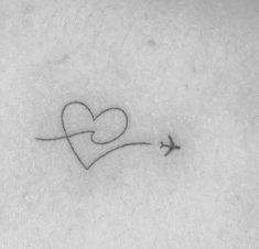 a small heart and an airplane tattoo on the stomach