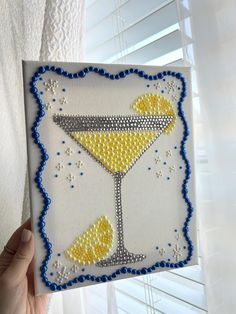 someone is holding up a handmade card with an image of a martini