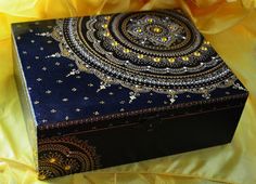 a decorative box sitting on top of a yellow cloth