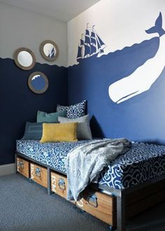 a blue and white bedroom with a whale painted on the wall