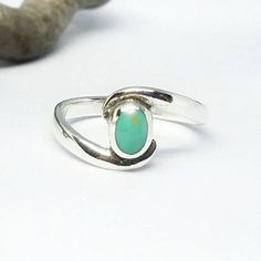 This Turquoise gemstone ring was created in solid Sterling Silver. The face of the ring is set with a slightly domed,round shaped Turquoise cabochon and is framed with a uniquely designed band that cradles the stone. The face of the ring measures 10mm.~Turquoise is one of the oldest protection amulets, and was also known as a symbol of wealth in many ancient cultures. A gift of Turquoise stone was said to protect the wearer from negative energy and bring wealth and good fortune. Turquoise also i Oval Turquoise Promise Ring, Turquoise Sterling Silver Opal Ring Gift, Turquoise Opal Ring In Sterling Silver For Gift, Turquoise Cabochon Opal Ring For Gift, Turquoise Rings For May Birthstone Gifts, Gift Turquoise Oval Cabochon Ring, Turquoise Sterling Silver Opal Ring For Promises, Sterling Silver Turquoise Opal Promise Ring, Turquoise Natural Stone Promise Ring