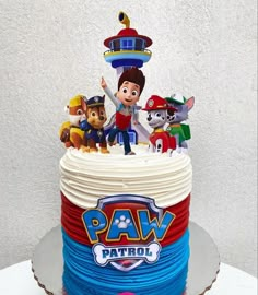 a birthday cake with paw patrol characters on top