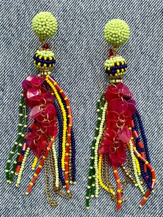 The art of beadwork has been practiced since the 16th Century. These lively beaded earrings are a modern take on the traditional craft. At once delicate and dramatic, these long chandelier earrings are light weight and eminently wearable. "Cha Cha Real Smooth" tassel earrings, 5" long Traditional Multicolor Beaded Earrings With Beaded Chain, Traditional Multicolor Beaded Chain Earrings, Traditional Tassel Earrings With Dangling Beads, Dangle Tassel Chandelier Earrings, Traditional Chandelier Earrings With Colorful Beads, Bohemian Beaded Earrings For Celebration, Green Beaded Earrings With Dangling Beads For Celebrations, Traditional Chandelier Drop Earrings With Colorful Beads, Green Beaded Dangling Earrings For Celebration