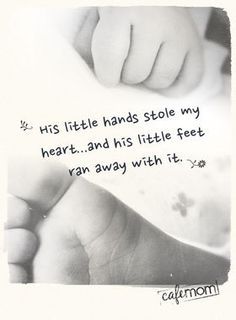 a black and white photo with a hand holding the foot of a baby's leg