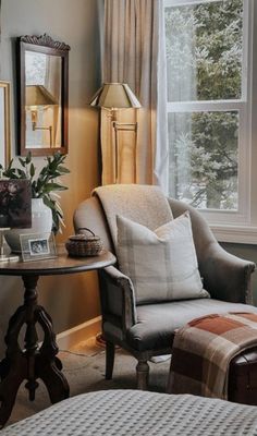 a living room filled with furniture and pictures on the wall next to a window covered in curtains