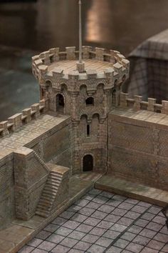 a model of a medieval castle with stairs and turrets on the outside, as well as steps leading up to it