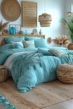 a bed with blue comforters and pillows in a room next to wicker baskets