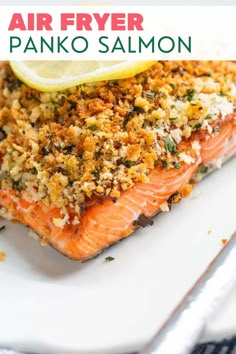 salmon fillets on a white plate with lemon wedges and parmesan crumbs