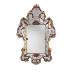 an ornate mirror with flowers and leaves on it