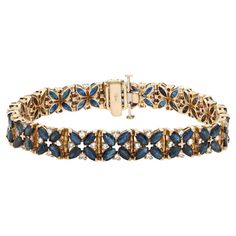 This beautifully crafted tennis bracelet features marquise cut blue Sapphires accented by round brilliant cut diamonds in prong setting. Crafted in 14k yellow gold. Total blue Sapphire weight: 8.00 carats. Total diamond weight: 1.00 carat. Length: 7 inches. Width: 8.9 mm. Total weight: 25.50 grams. Bracelet closes securely with a box clasp. This tennis bracelet is a timeless piece that holds a place in the collection of every jewelry lover. Comes with a presentable gift box and appraisal. Luxury Yellow Gold Sapphire Tennis Bracelet, Luxury Blue Gold Classic Bracelet, Bracelet Tennis, Marquise Cut, Tennis Bracelet, Round Brilliant Cut Diamond, Jewelry Lover, Brilliant Cut Diamond, Timeless Pieces