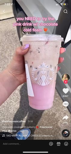 a woman holding up a pink drink with the caption, you need to try the pink drink w / chocolate cold foam