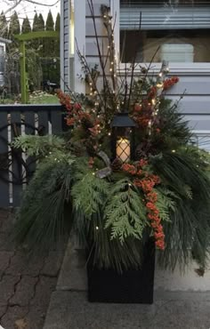 a planter filled with lots of greenery sitting on the side of a house