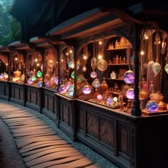 a row of shelves filled with lots of different types of glass bottles and lights on top of them