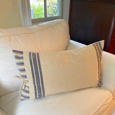 a white couch with two pillows on it