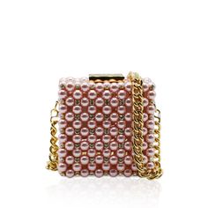 Handcrafted with care in Italy with up to 8 hours of hand work, this clutch is a masterpiece of luxury. This clutch boasts a metal frame available in gold or silver, delicately adorned with Artisan pearls and sparkling crystals, catching the light with every movement.Luxurious leather graces the interior, offering both sophistication and functionality. Material: Metal Frame, Artisan pearls and sparkling crystals, Leather Unlined Height: 10 cm Width: 10 cm Depth: 6 cm Complete with a versatile 80