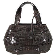 Nancy Gonzalez large dark brown crocodile double handle handbag. This beautiful bag is perfect for dressy to casual wear, two wide handles are detailed with cross stitching. The oval shape bag closes at the top with hidden magnetic closures, and an a crocodile tab that closes at the center. The bag has a soft puffy shape. The bag is lined in lavender suede, inside there is zipper compartment, and an open pocket with a phone pocket. There are two self tassels at one handle, 4 feet at the oval bot Luxurious Closet, Rich Lady, Nancy Gonzalez, Handle Bag, Cross Stitching, Beautiful Bags, Fashion Handbags, Top Handle, Dark Brown