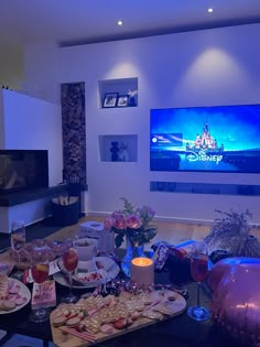 a living room filled with furniture and a flat screen tv mounted to the side of a wall