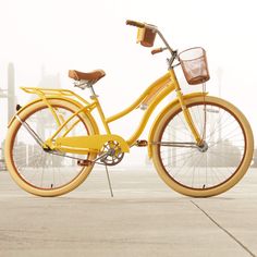 a yellow bicycle is parked on the pavement