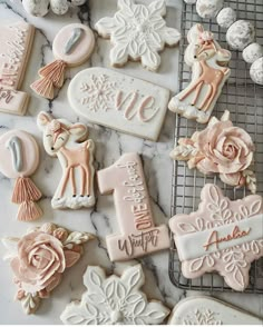 some decorated cookies are sitting on a cooling rack next to other cookie decorating items