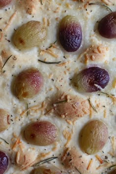 a pizza with olives and cheese on it sitting on top of a countertop