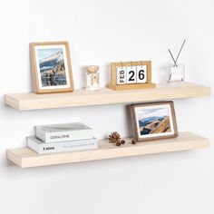 two wooden shelves with pictures and books on them